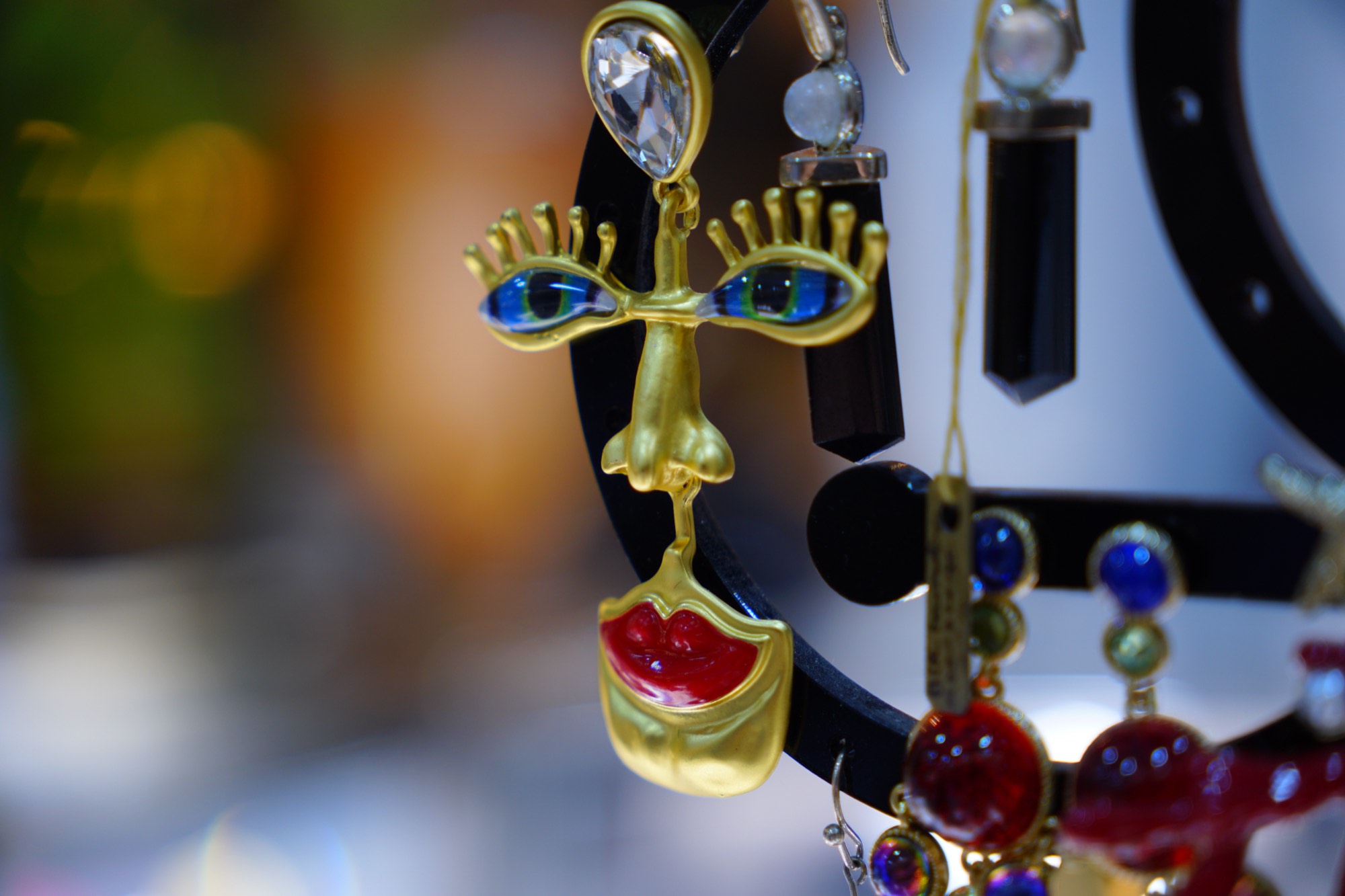 Earrings on a stand, the display cases behind